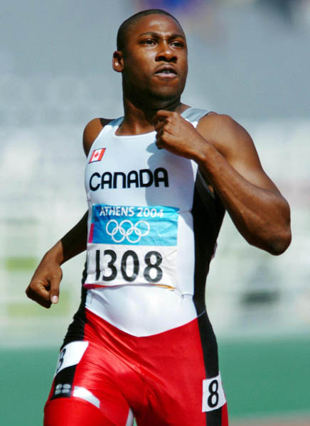Canadian sprinter Pierre Brown of Toronto, Ontario, checks out his time after running during the 100m heat during the Athens 2004 Summer Olympic Games Saturday, August 21, 2004. Brown crossed the line with a time of 10.32 to move on. (CP PHOTO/COC-Andre Forget)