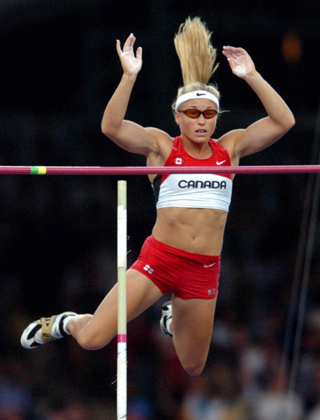 Dana Ellis of Kitchener, Ont. jumps over the bar during pole vault qualifications during the Athens 2004 Summer Olympic Games August 21, 2004. (CP PHOTO /COC-Andre Forget)