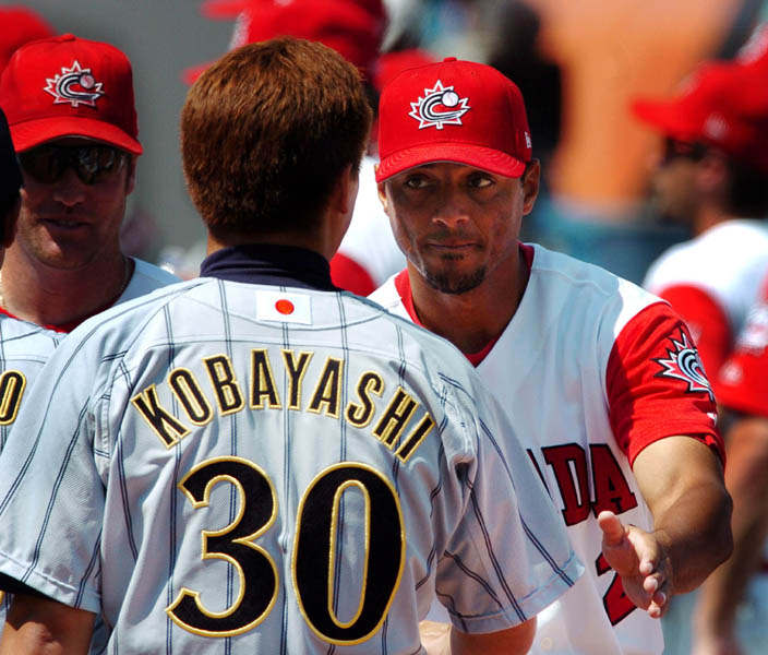 Canada's mens baseball team player Rob Ducey congratulates Japans closing pitcher Masahide Kobayashi after losing 2-11 during the bronze medal match of the Athens 2004 Summer Olympic Games Wednesday August 25, 2004. Japan went on to win bronze. (CP PHOTO/COC-Andre Forget)