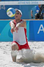 Mark Heese of Toronto goes up for the ball against Patrick Heuscher of Switzerland in Canada's loss in beach volleyball at the Athens Olympics, Saturday, August 14, 2004. (CP PHOTO/COC-Mike Ridewood)