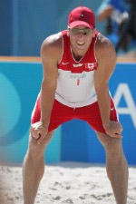 Mark Heese of Toronto goes up for the ball against Patrick Heuscher of Switzerland in Canada's loss in beach volleyball at the Athens Olympics, Saturday, August 14, 2004. (CP PHOTO/COC-Mike Ridewood)
