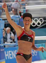 Guylaine Dumont of St-Antoine-de-Tilly, Que. gets ready to hit the ball as Annie Martin of Sherbrooke, Que., (facing the camera) watches her during a beach volleyball game at the Olympic Games in Athens, Saturday, August 14, 2004. (CP PHOTO/COC-Mike Ridewood)