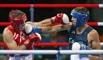 Canada's Adam Trupish (right) of Windsor, Ont. lost the bout against Ruslan Khairov of Azerbiajan at the Olympic Games in Athens, Sunday, August 15, 2004 due to an injury. (CP PHOTO/COC-Mike Ridewood)