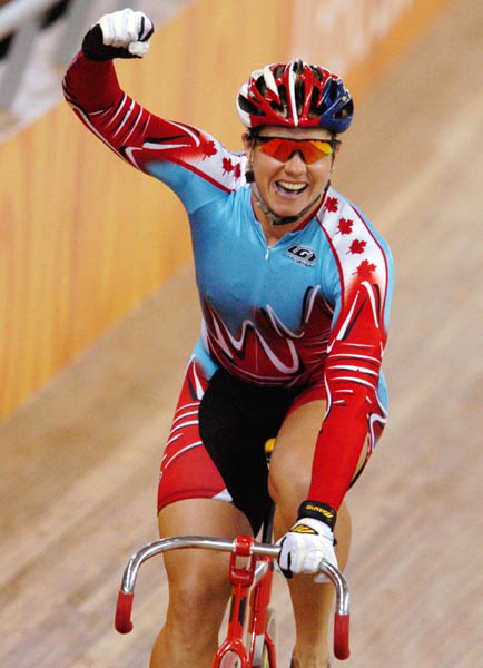 Canada's Lori-Ann Muenzer from Edmonton celebrates after winning the gold medal in women's sprint cycling at the 2004 Summer Olympic Games in Athens, Greece, Tuesday,  August 24, 2004. (CP PHOTO/COC/Andre Forget)