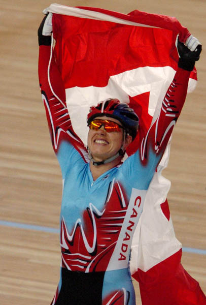 FILE--Canada's Lori-Ann Muenzer from Edmonton celebrates with the Canadian flag after winning the gold medal in the women's sprint against Russia's Tamilla Abassova at the 2004 Summer Olympic Games in Athens, Greece, Tuesday,  August 24, 2004. (CP PICTURE ARCHIVE/COC/Andre Forget)