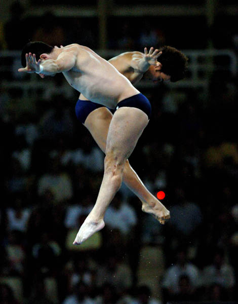 Alexandre Despatie and Philippe Comtois dive during the 10m synchronised diving at the Athens 2004 Summer Olympic Games August 14, 2004. (CP PHOTO 2004/Andre Forget/COC)