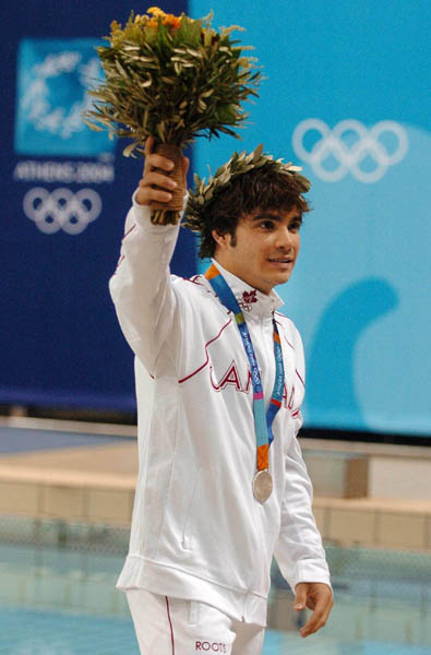 Alexandre Despatie of Montreal salutes the crowd after winning the silver medal during the mens 3m springboard at the Athens 2004 Summer Olympic Games Tuesday, August 24, 2004. (CP PHOTO/COC-Andre Forget)