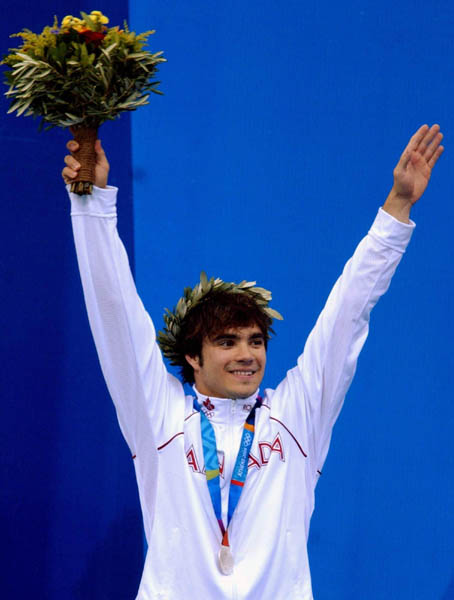 Alexandre Despatie of Montreal celebrates on the podium after winning the silver medal in the men's 3m springboard event at the 2004 Summer Olympic Games in Athens, Greece, Tuesday,  August 24, 2004. (CP PHOTO/COC/Andre Forget)