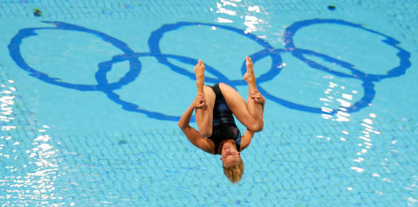Canada's Emily Heymans of St-Lambert, Que. flies over the Olympic rings on her way to a tenth-place finish in the women's 3-metre springboard final at the Summer Olympics in Athens, Greece, Thursday, August 26, 2004.(CP PHOTO/COC/Mike Ridewood)