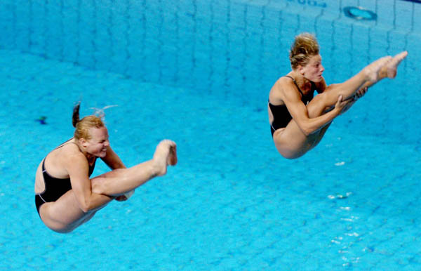 Blythe Hartley (L) and team mate Emilie Heymans  dive during the Synchronised Diving 3m Springboard at the Athens 2004 Summer Olympic Games August 14, 2004. (CP PHOTO 2004/Andre Forget/COC)
