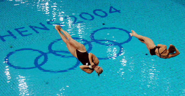 Blythe Hartley (L) and team mate Emilie Heymans  dive during the Synchronised Diving 3m Springboard at the Athens 2004 Summer Olympic Games August 14, 2004. (CP PHOTO 2004/Andre Forget/COC)
