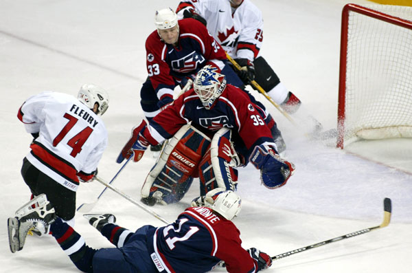 Theoren Fleury (74) tries to score on USA goalie Mike Richter during hockey action Sunday Feb. 24, 2002 at the 2002 Olympic Winter Games in Salt Lake City. Team Canada won 5-2 over Team USA for the gold. (CP Photo/COA/Andre Forget).