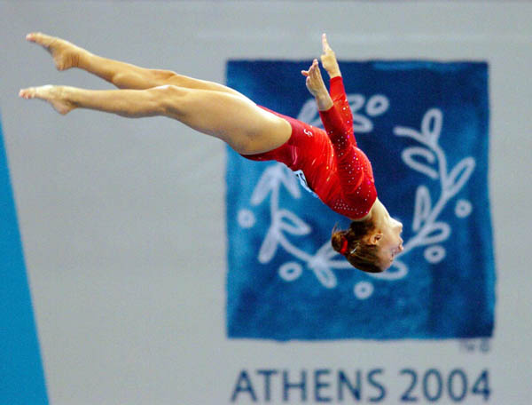 Amelie Plante of Canada flies over the beam during women's gymnastics qualifications at the 2004 Olympic Games in Athens, Sunday, Aug. 15, 2004. (CP PHOTO/COC-Andre Forget)