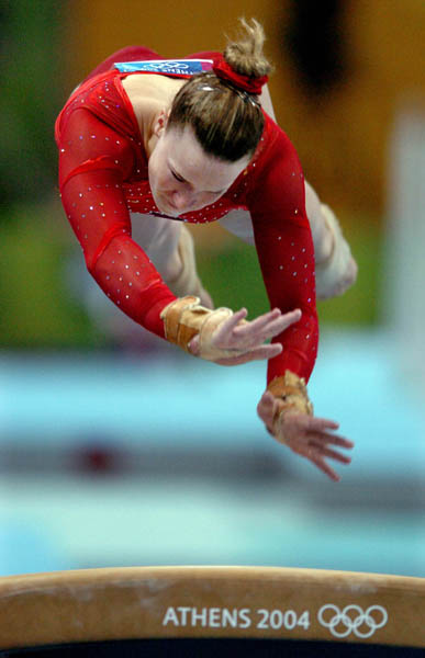 Mary Heather Purnell of Canada flies over the vault during women's gymnastics qualifications at the 2004 Olympic Games in Athens, Sunday, Aug. 15, 2004. (CP PHOTO/COC-Andre Forget)