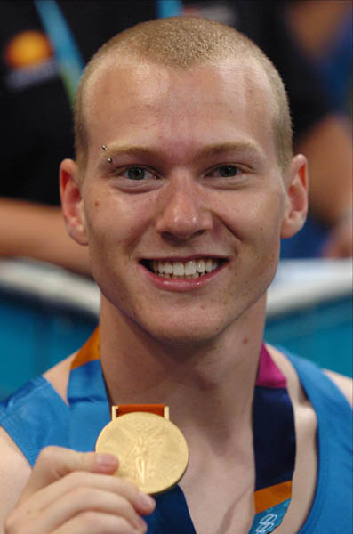 Canada's Kyle Shewfelt displays his gold medal from the men's Floor routine at the Athens 2004 Summer Olympic Games August 22, 2004. (CP PHOTO 2004/Andre Forget/COC)