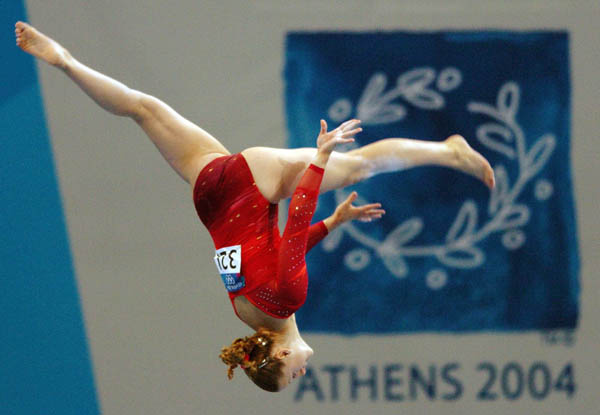 Kylie Stone of Canada flies over the beam during women's gymnastics qualifications at the 2004 Olympic Games in Athens, Sunday, Aug. 15, 2004. (CP PHOTO/COC-Andre Forget)