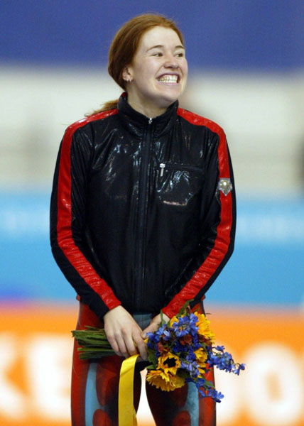 Clara Hughes celebrates her bronze medal in the women's 5,000 metre long track speed skating race at the 2002 Olympic Winter Games in Salt Lake City. (CP PHOTO/COA/Mike Ridewood).
