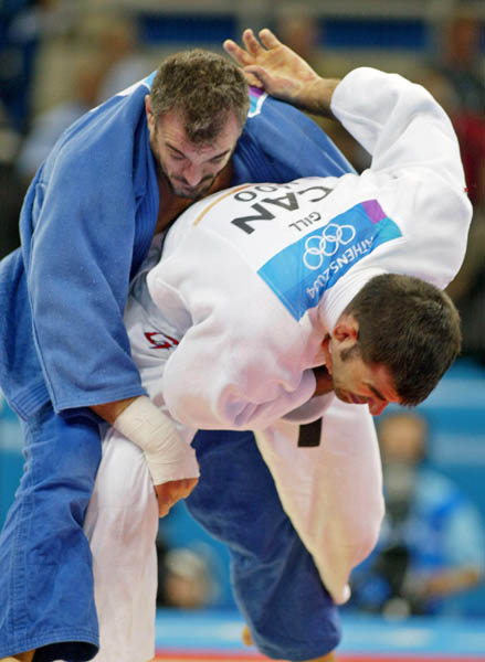 Canada's Nicolas Gill, (bottom) from Montreal, is thrown by Italy's Michele Monti in the -100kg judo competition at the Summer Olympics in Athens Thursday, August 19, 2004. Gill, Canada's flag bearer and medal hopefull, lost the first round match. (CP PHOTO/COC-Mike Ridewood)