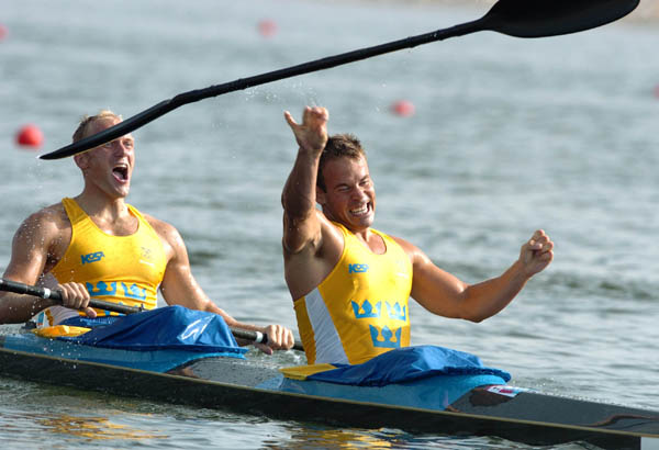 Sweden's Markus Oscarsson (front) throws his paddle as he team mate Henrik Nilsson celebrates their gold medal run during the K2 1000m final during the Athens 2004 Summer Olympic Games in Schinias, Greece, on Friday, August 27, 2004. (CP PHOTO 2004/Andre Forget/COC)