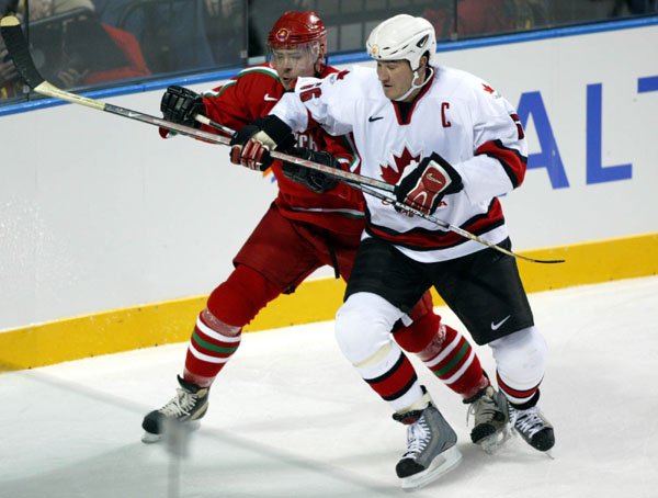 Canada's Mario Lemieux in action against his Belarus opponent in the semifinal at the 2002 Olympic Winter Games in Salt Lake City. (CP PHOTO/COA/Andr Forget).
