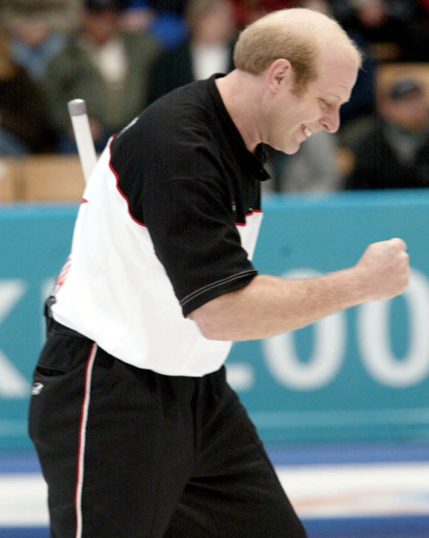 Kevin Martin of Edmonton celebrates landing his team's 6 - 4 win over Sweden in the men's curling semi-final in Ogden, Utah during the 2002 Olympic Winter Games, Feb. 20, 2002.  (CP PHOTO/COA/Mike Ridewood).