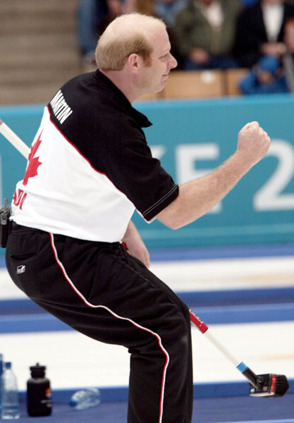 Kevin Martin of Edmonton celebrates landing his team's 6 - 4 win over Sweden in the men's curling semi-final in Ogden, Utah during the 2002 Olympic Winter Games, Feb. 20, 2002.  (CP PHOTO/COA/Mike Ridewood).