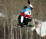 Canadian Mike Michalchuk of Calgary pulls a trick while riding the  half pipe at Park City, Utah Monday  Feb. 11, 2002 at the Salt Lake City 2002 Winter Olympics. (CP Photo/HO/COA/Andre Forget)