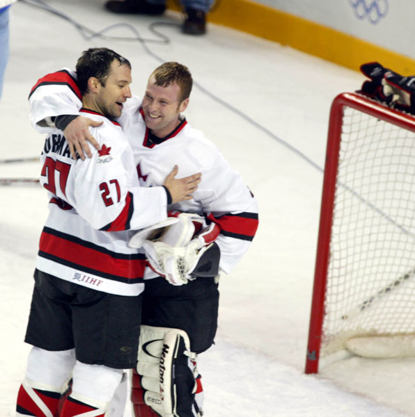 Scott Niedermayer (27) congratulates goalie Martin Brodeur after the victory over Team USA in the final at the 2002 Olympic Winter Games in Salt Lake City. Team Canada won 5-2 over Team USA.  (CP Photo/COA/Andre Forget).