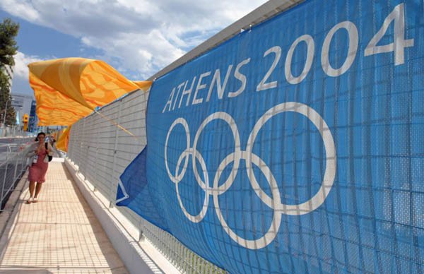 The wind sends banners flying over the sidewalk by the main Press centre for the 2004 Summer Olympics in Athens, Saturday, Aug. 7, 2004. Opening ceremonies take place next Friday.  (CP PHOTO/ho, COC - Mike Ridewood)