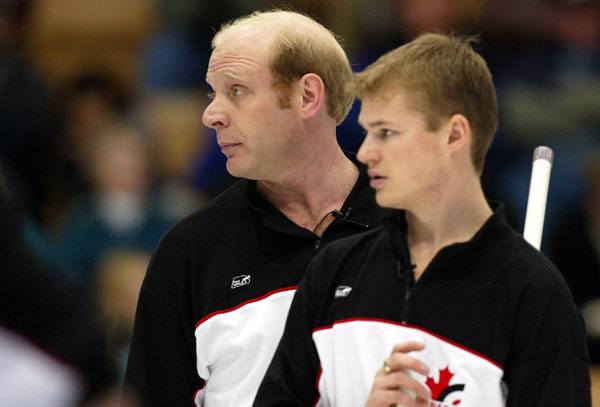 Canadian men's curling skip Don Martin and second Carter Rycroft look at their score at the 2002 Olympic Winter Games at Ogden, Utah, 2002 . (CP PHOTO/COA/Mike Ridewood).