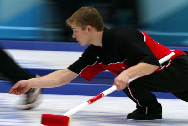 Canadian men's curling second Carter Rycroft tries to place his stone. Canadian Team lost  6 - 5 in the gold medal game against Norway during the 2002 Winter Olympic Games at Ogden, Utah, Friday Feb. 22, 2002 . (CP PHOTO/COA/Mike Ridewood).