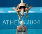 Anouk Reniere-Lafreniere flips through the air during the Canadian syncronized swiming team's practice during the Athens 2004 Summer Olympic Games on Tuesday Aug. 10 2004. (CP PHOTO 2004/Andre Forget/COC)