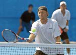 Frederic Niemeyer (foreground) of Campbellton, N.B. and Daniel Nestor of Willowdale, Ont. return the ball during their win over Slovakia in the first round of doubles tennis at the Athens Olympics, Sunday, August 15, 2004.  (CP PHOTO/COC-Mike Ridewood)