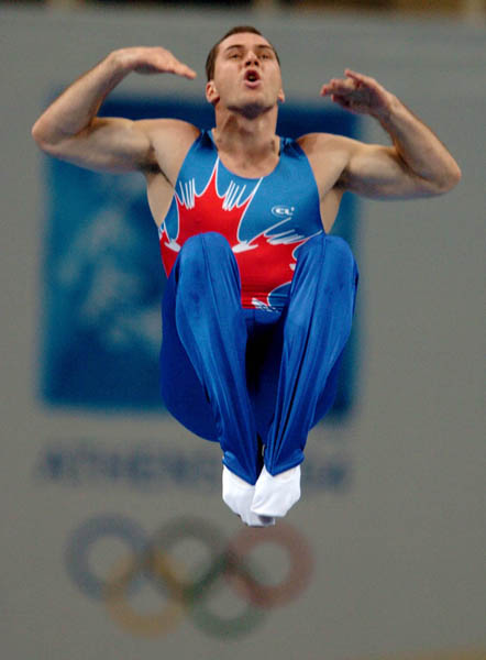Mathieu Turgeon of Pointe-Claire, Que. performs during the qualification round of trampoline during the Athens 2004 Summer Olympic Games August 21, 2004. Turgeon did not advance. (CP PHOTO/COC-Andre Forget)