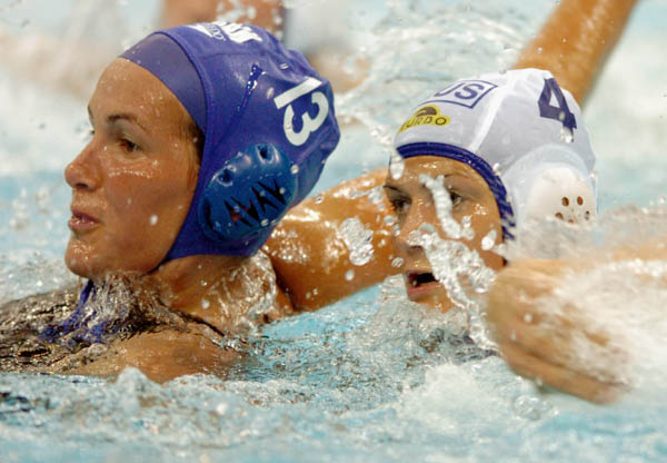 Canadian Johanne Begin battles with Sofya Konukh during Waterpolo action against Russia during the Athens 2004 Summer Olympic Games August 16, 2004. (CP PHOTO 2004/Andre Forget/COC)