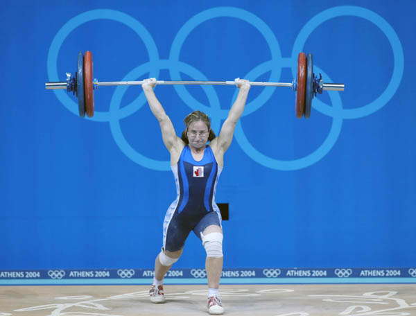 Canada's Maryse Turcotte, from Montreal, makes her lift at the women's 58kg weightlifting final at the Summer Olympics in Athens Monday, August 16, 2004.  (CP PHOTO/COC-Mike Ridewood)