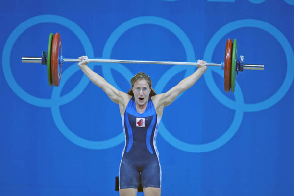 Canada's Maryse Turcotte, from Montreal, makes her lift at the women's 58kg weightlifting final at the Summer Olympics in Athens Monday, August 16, 2004.  (CP PHOTO/COC-Mike Ridewood)