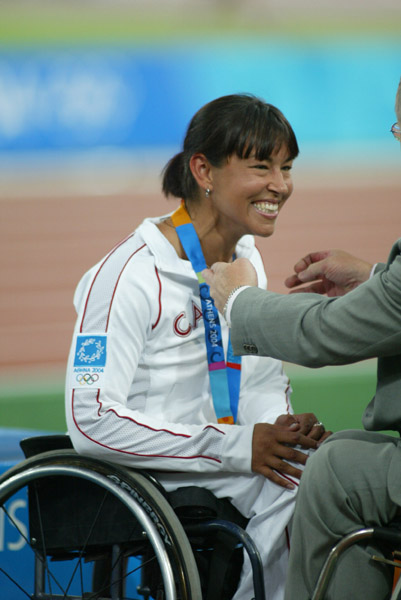 Canada's Chantal Petitclerc of Montreal receives her gold medal won in women's wheelchair 800 metres in track and field action at the Athens Olympics, Sunday, August 22, 2004.(CP PHOTO/COC-Mike Ridewood)