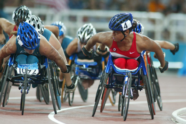 Canada's Chantal Petitclerc (right) of Montreal keeps an eye on Eliza Stankovich of Australia in women's wheelchair 800 metres in track and field action at the Athens Olympics, Sunday, August 22, 2004.(CP PHOTO/COC-Mike Ridewood)
