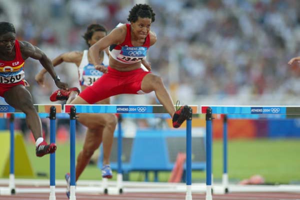 Canada's Angela Whyte of Edmonton, Alberta, in her heat of women's 100 metre hurdles in track and field action at the Olympic Games in Athens, Sunday, August 22, 2004.(CP PHOTO)2004(COC-Mike Ridewood)