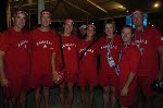 Canada's 2004 beach volleyball team during the Canadian flag raising ceremony at the Olympic Games in Athens.  From left to right: Mark Heese, John Child, Guylaine Dumont, Annie Martin, Caroline Sharp (executive director, Volleyball Canada), Vincent Larive (coach) and John May (team leader). (CP PHOTO 2004/Andre Forget/COC)