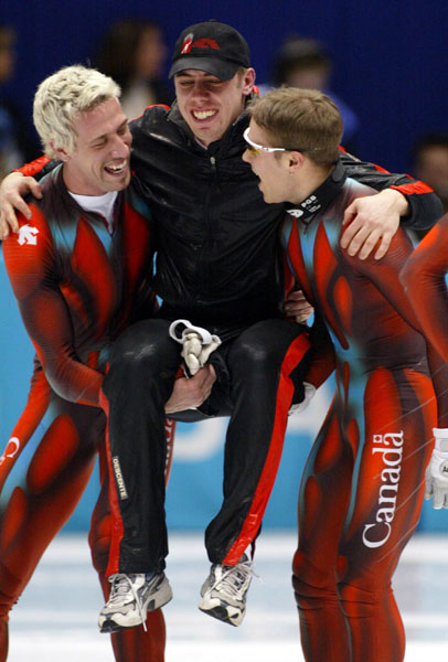 Canadian Short Track Gold medallists (L-R) Marc Gagnon, Eric Bedard, and  Mathieu Turcotte celebrate after winning gold in the Men's 5000 metre Relay Saturday Feb. 23, 2002 at the 2002 Olympic Winter Games in SaltLake City. (CP Photo/COA/Andre Forget)