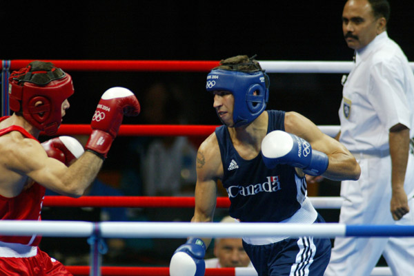 Adam Trupish (right) of Windsor, Ont. fights Khairov of Azerbiajan at the Olympic Games in  Athens, Sunday, August 15, 2004. Trupish lost the bout due to an injury. (CP PHOTO/COC-Mike Ridewood)