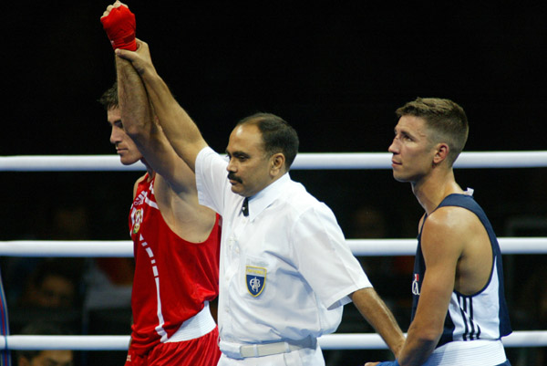 Canada's Adam Trupish (right) of Windsor, Ont. lost the bout against Ruslan Khairov of Azerbiajan at the Olympic Games in Athens, Sunday, August 15, 2004 due to an injury. (CP PHOTO/COC-Mike Ridewood)