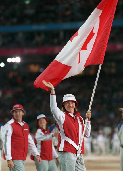 Canada's Caroline Brunet carries the Canadian flag during the opening ceremonies at the Sydney 2000 Olympic Games. (CP PHOTO/ COA)