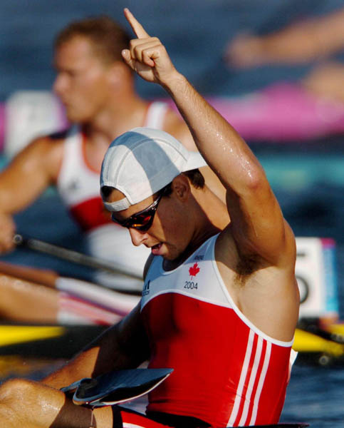 Canada's Adam van Koeverden of Burlington, Ontario pumps his hand after racing in the K1 500m heat during the Athens 2004 Summer Olympic Games  Tuesday August 24, 2004. van Koeverden placed first in the heat. (CP PHOTO/COC-Andre Forget)