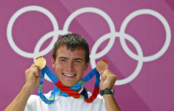 Canada's Adam van Koeverden of Toronto poses with his gold and bronze medals after being named the flag bearer for the closing ceremonies at the Athens Olympics Sunday, August 29, 2004.(CP PHOTO/COC-Mike Ridewood)