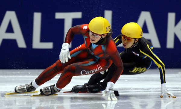 Canadian short track speed skater Isabelle Charest is followed closely by Japan's Chikage Tanaka during the Women's 500 metre in Salt Lake City, Utah Saturday Feb. 16, at the 2002 Olympic Winter Games. (CP Photo/COA/Andre Forget).