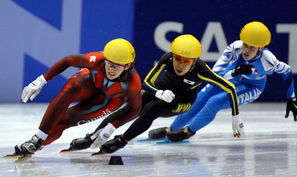 Canadian short track speed skater Isabelle Charest is followed closely during the Women's 500 metre in Salt Lake City, Utah Saturday Feb. 16, at the 2002 Olympic Winter Games. (CP Photo/COA/Andre Forget).