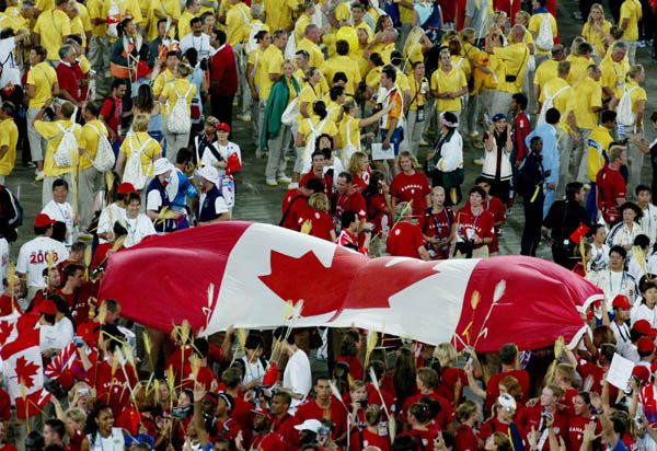 Canadian team members carry a large flag during closing ceremonies at the Summer Olympics in Athens Sunday, August 29, 2004. (CP PHOTO/COC-Andre Forget)